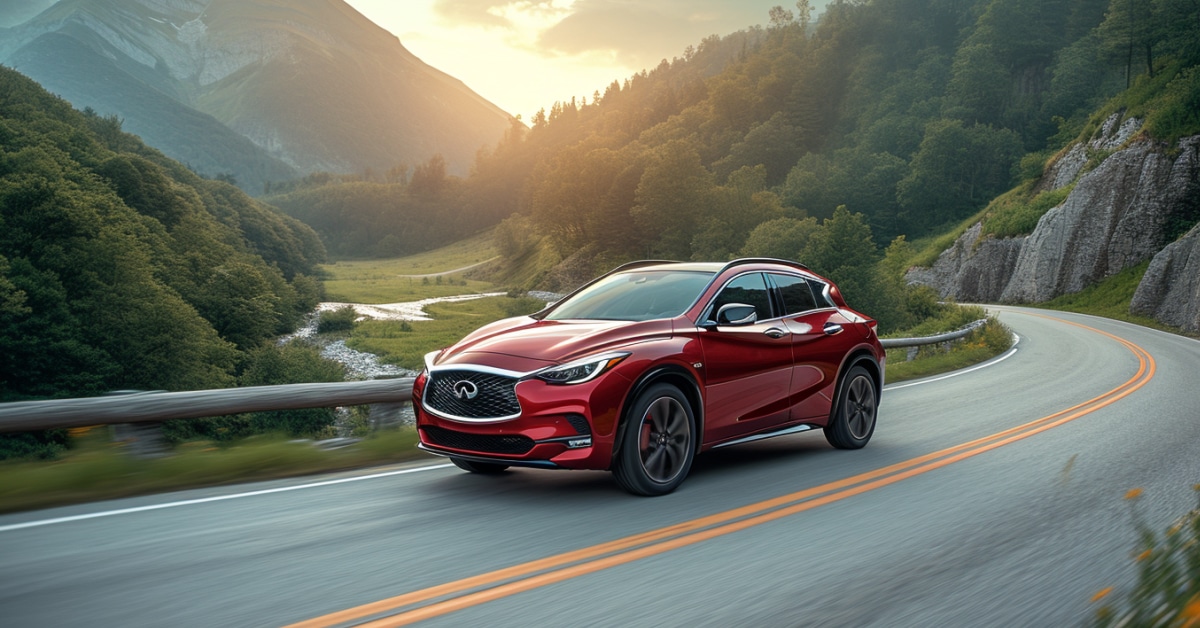 Red Infiniti QX30 driving up curvy mountain road at sunrise