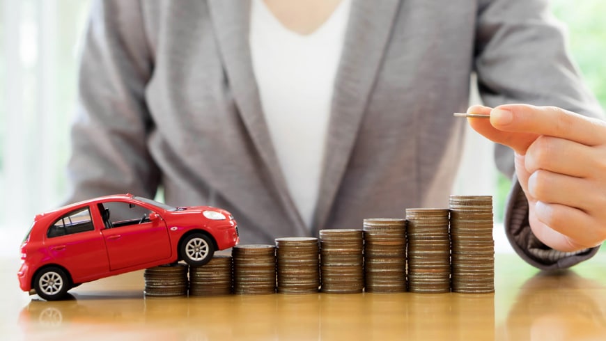 insurance agent stacking coins with toy car