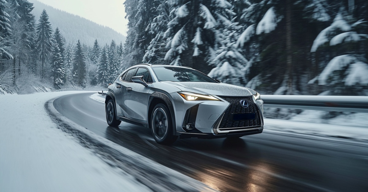 Lexus UX 250h driving up wet snowy mountain highway