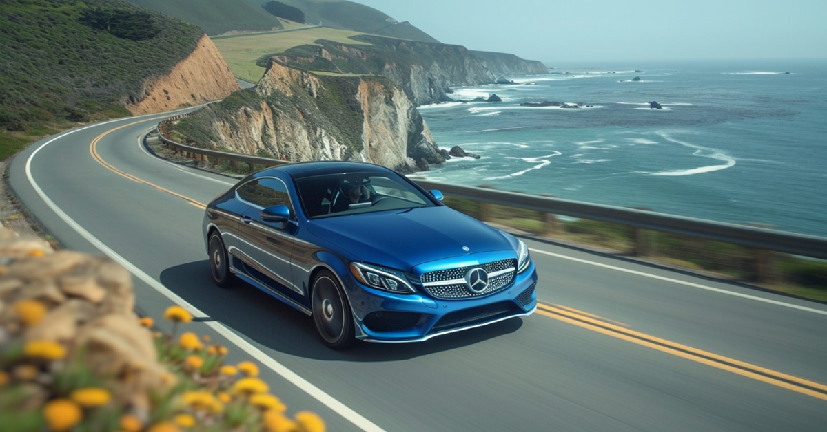 Mercedes-Benz C350 driving on coastal highway